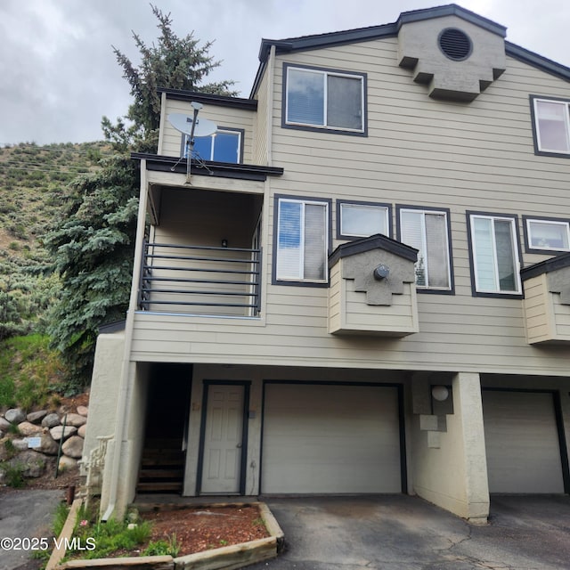 600 Nottingham Rd Unit 15, Avon, CO 81620 - townhome / multi-family property with a balcony, a garage, and asphalt driveway