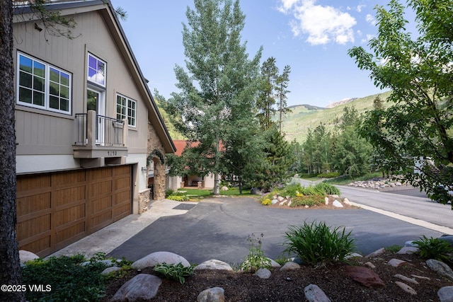 4240 Spruce Way, Vail, CO 81657 - view of yard featuring a mountain view, driveway, and a garage