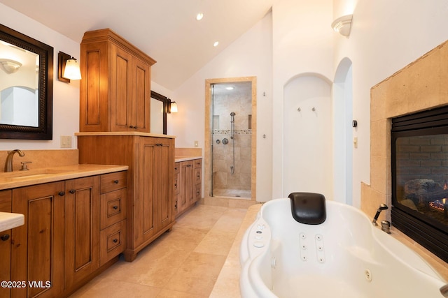 4240 Spruce Way, Vail, CO 81657 - full bath with a glass covered fireplace, a stall shower, a jetted tub, vanity, and high vaulted ceiling