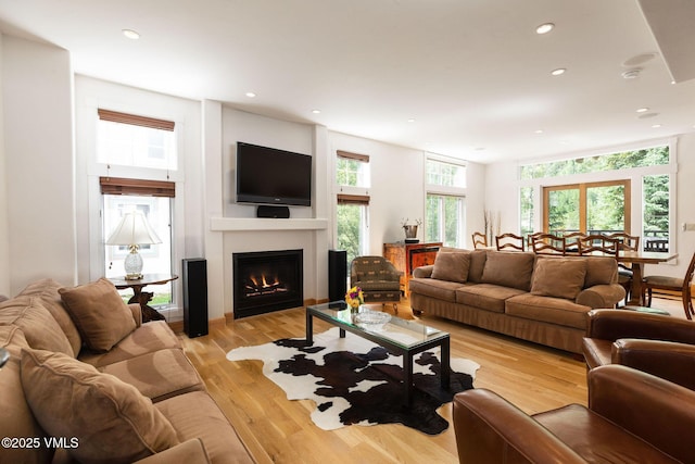 4240 Spruce Way, Vail, CO 81657 - living room with recessed lighting, a lit fireplace, and light wood-style flooring