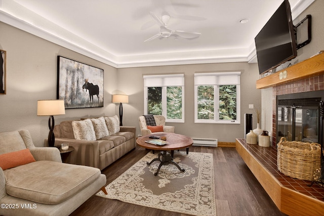 120 Offerson Unit 5160, Beaver Creek, CO 81620 - living area featuring a tile fireplace, dark wood-style floors, a ceiling fan, and a baseboard heating unit
