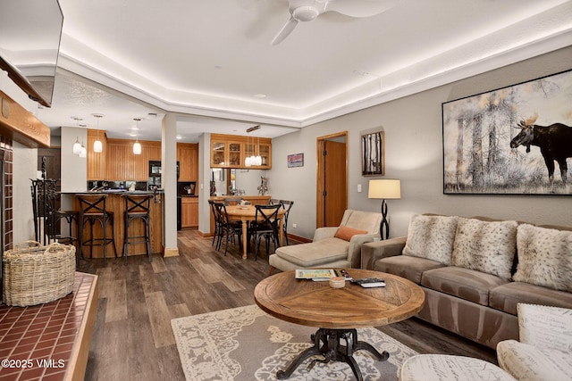 120 Offerson Unit 5160, Beaver Creek, CO 81620 - living area with dark wood finished floors, a ceiling fan, and a tray ceiling