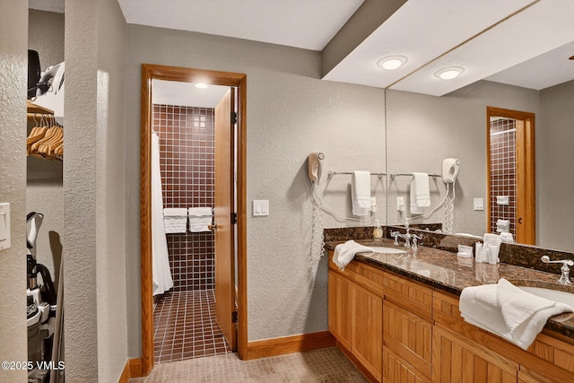 120 Offerson Unit 5160, Beaver Creek, CO 81620 - bathroom featuring a textured wall, double vanity, and tile patterned floors