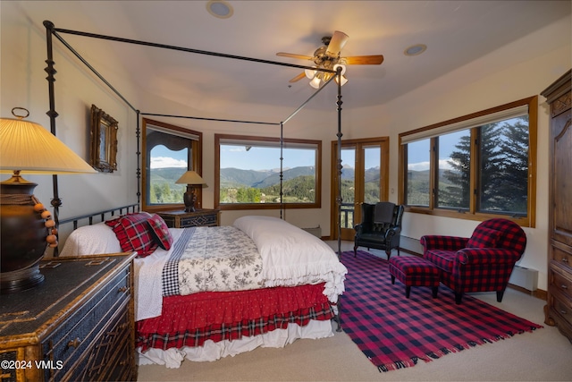 carpeted bedroom with access to exterior and a mountain view