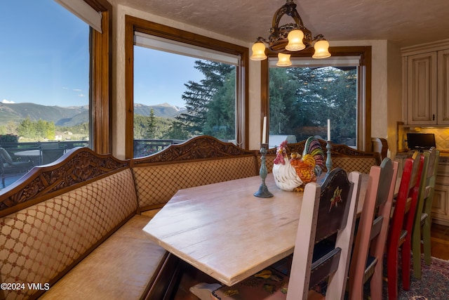 dining space featuring a mountain view and an inviting chandelier