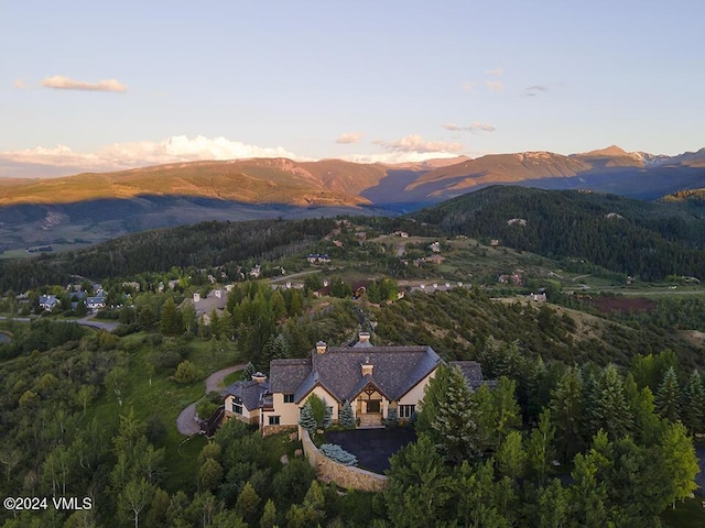 aerial view at dusk featuring a mountain view