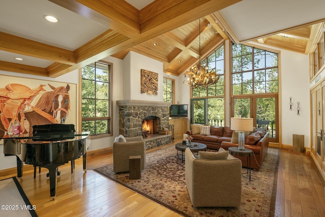 416 Forest Rd Unit A, Vail, CO 81657 - living room with healthy amount of natural light, hardwood / wood-style floors, a stone fireplace, a chandelier, and high vaulted ceiling