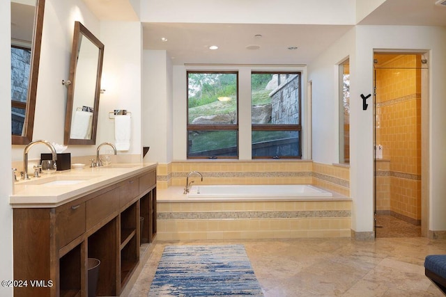 bathroom with vanity and separate shower and tub