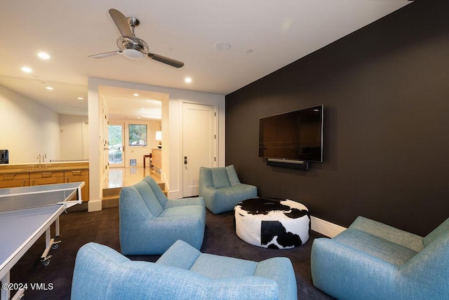 living room featuring sink and ceiling fan