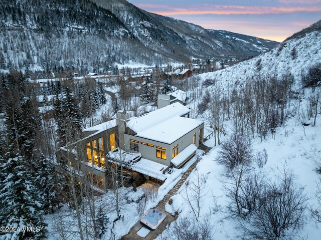 snowy aerial view featuring a mountain view