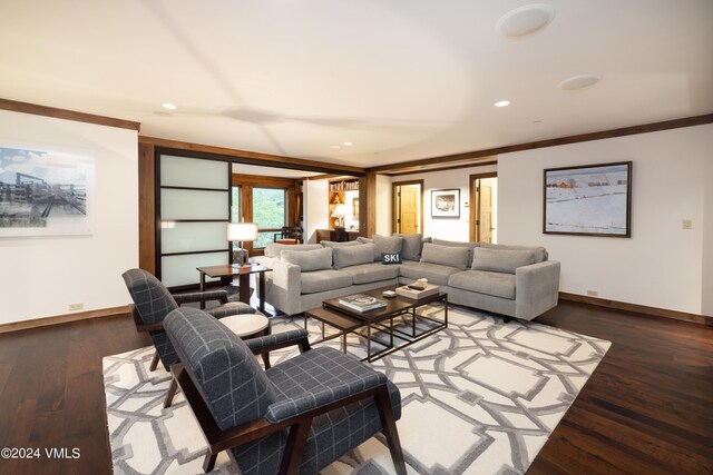 living room featuring wood-type flooring and crown molding