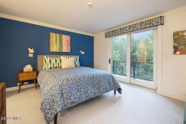 carpeted bedroom featuring access to outside