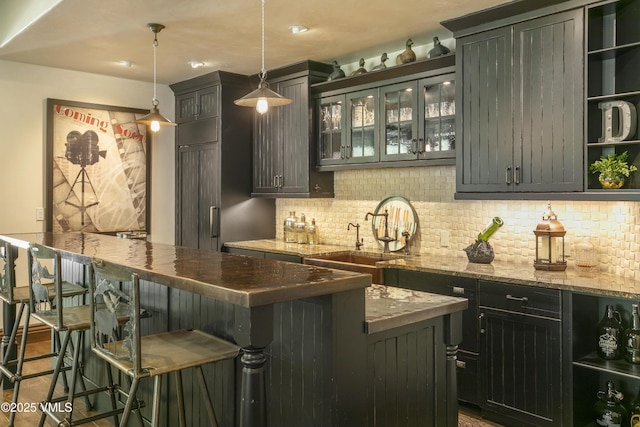179 S Fairway Dr, Beaver Creek, CO 81620 - indoor wet bar featuring backsplash, pendant lighting, and wood finished floors