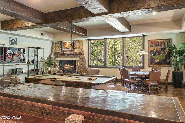 179 S Fairway Dr, Beaver Creek, CO 81620 - living area featuring a stone fireplace, beam ceiling, and wood finished floors