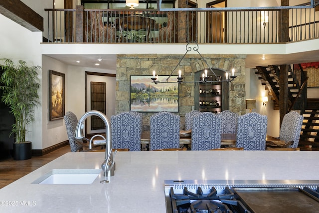 179 S Fairway Dr, Beaver Creek, CO 81620 - kitchen with a high ceiling, wood finished floors, and a chandelier
