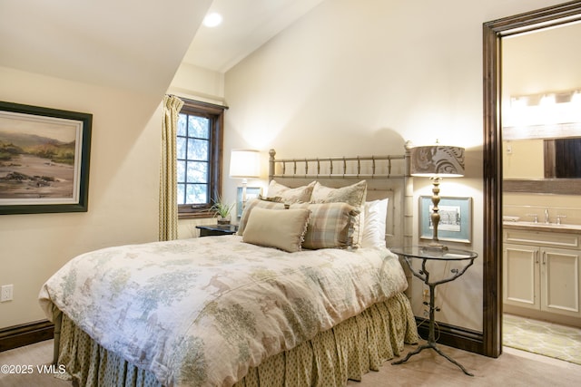179 S Fairway Dr, Beaver Creek, CO 81620 - bedroom with vaulted ceiling, light carpet, and ensuite bathroom