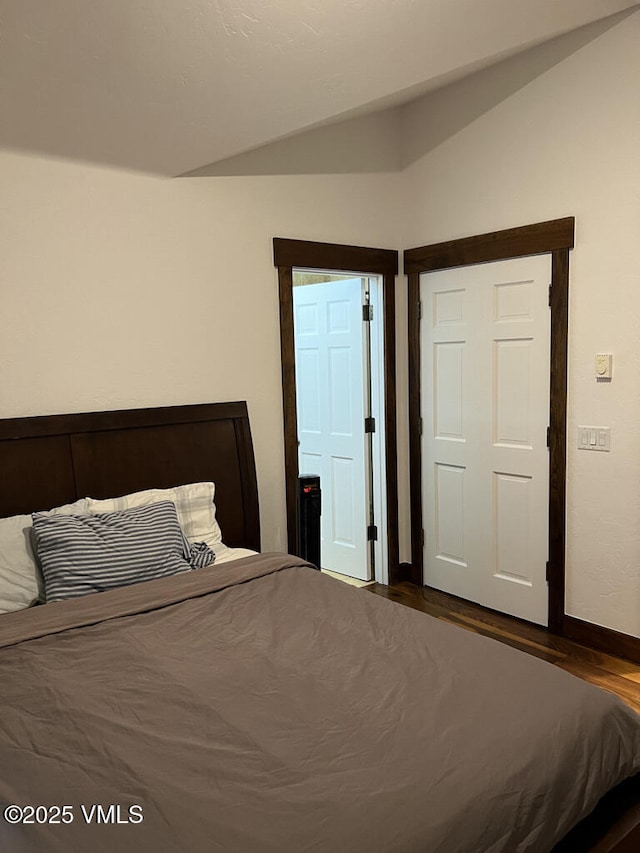 3105 Bellflower Dr, Vail, CO 81657 - bedroom with lofted ceiling, baseboards, and wood finished floors