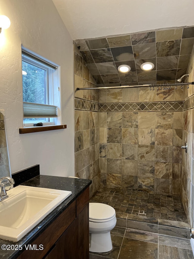 3105 Bellflower Dr, Vail, CO 81657 - full bath with toilet, tiled shower, vanity, and stone finish floor