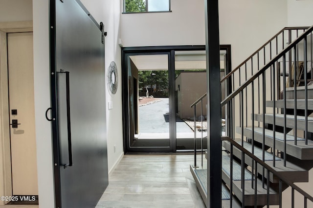 777 Potato Patch Dr Unit A, Vail, CO 81657 - entryway with stairway, wood finished floors, a towering ceiling, and a barn door