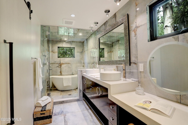 777 Potato Patch Dr Unit A, Vail, CO 81657 - full bathroom featuring a soaking tub, double vanity, a shower stall, and tile walls