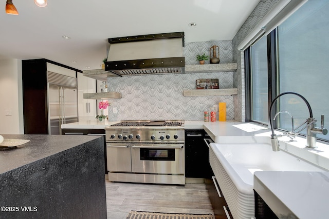 777 Potato Patch Dr Unit A, Vail, CO 81657 - kitchen featuring premium appliances, custom exhaust hood, open shelves, light wood-type flooring, and recessed lighting