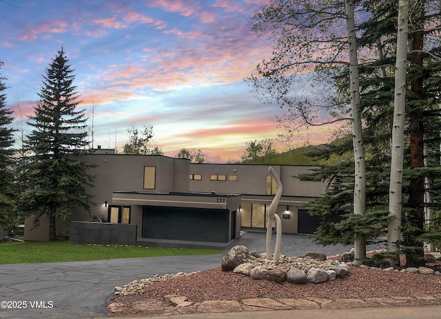 777 Potato Patch Dr Unit A, Vail, CO 81657 - modern home with stucco siding, asphalt driveway, and an attached garage