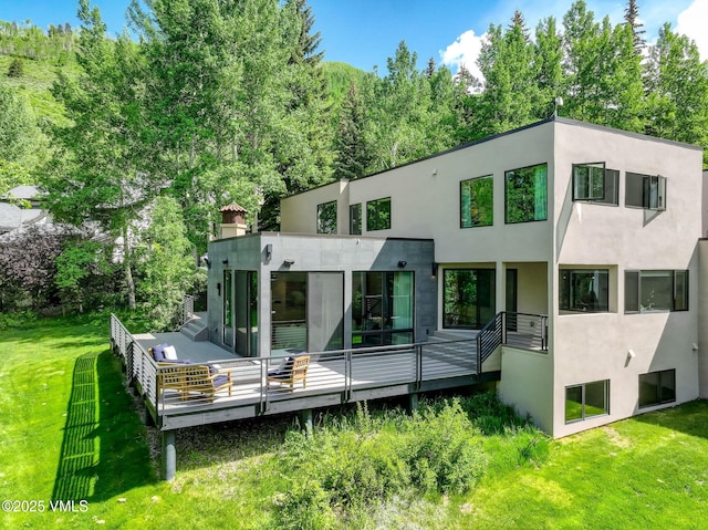 777 Potato Patch Dr Unit A, Vail, CO 81657 - rear view of property featuring a lawn, stucco siding, and a wooden deck