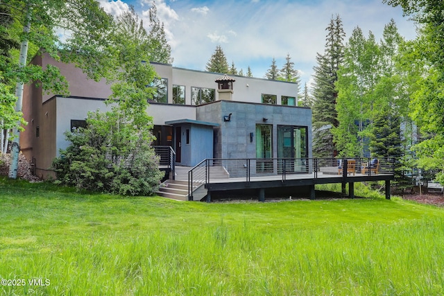 777 Potato Patch Dr Unit A, Vail, CO 81657 - rear view of property featuring a yard, a wooden deck, and stucco siding