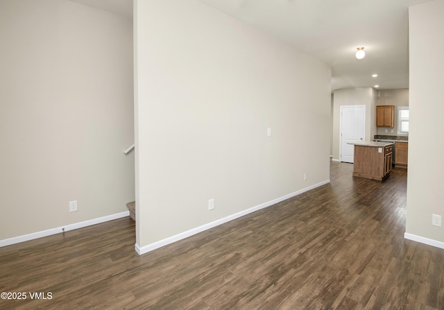 unfurnished living room featuring baseboards, recessed lighting, stairs, and dark wood-style floors