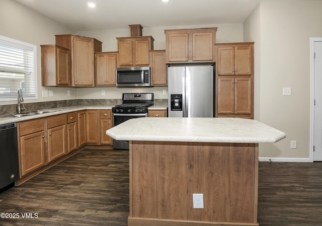 kitchen featuring recessed lighting, a sink, appliances with stainless steel finishes, and dark wood-style floors