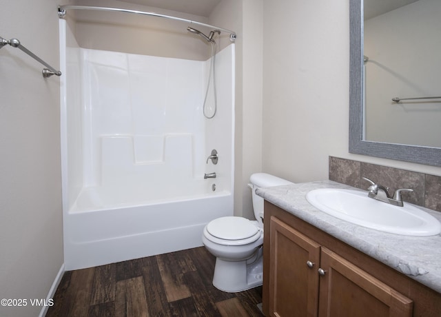 full bath with shower / bath combination, vanity, toilet, and wood finished floors