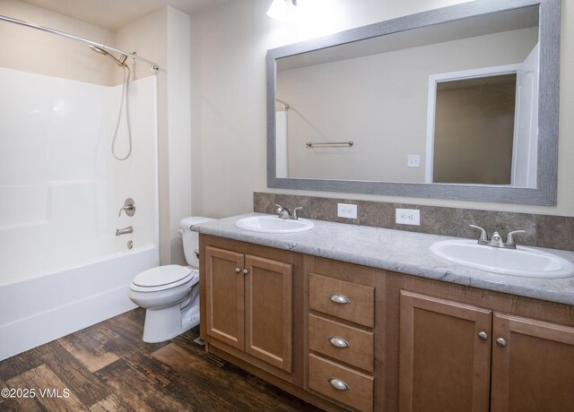 bathroom featuring double vanity, a sink, and wood finished floors