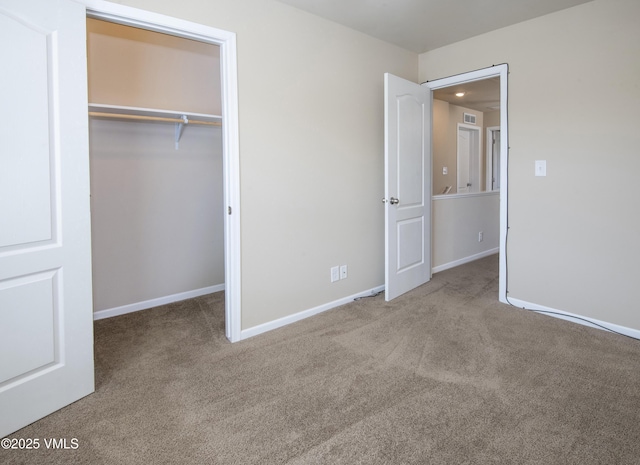 unfurnished bedroom with baseboards, carpet flooring, and a closet