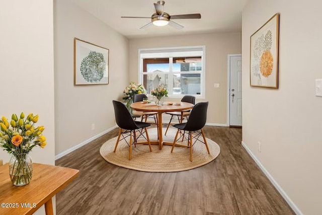 dining room with baseboards, ceiling fan, and wood finished floors