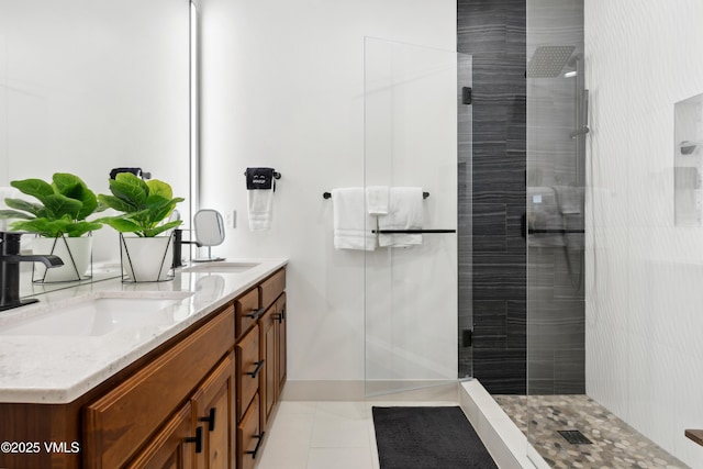 295 Main St Unit R305, Edwards, CO 81632 - bathroom with double vanity, tiled shower, tile patterned floors, and baseboards