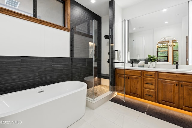 295 Main St Unit R305, Edwards, CO 81632 - full bath featuring a shower stall, double vanity, a freestanding tub, tile patterned floors, and tile walls