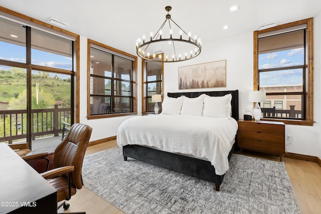 295 Main St Unit R305, Edwards, CO 81632 - bedroom featuring access to outside, a chandelier, wood finished floors, baseboards, and recessed lighting