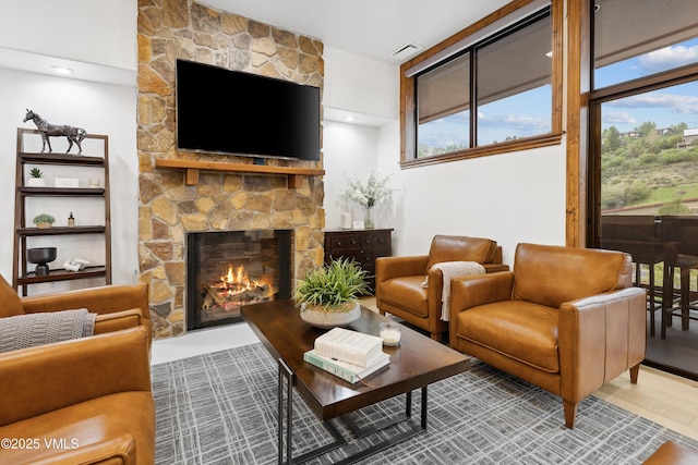 295 Main St Unit R305, Edwards, CO 81632 - living room featuring a stone fireplace and plenty of natural light
