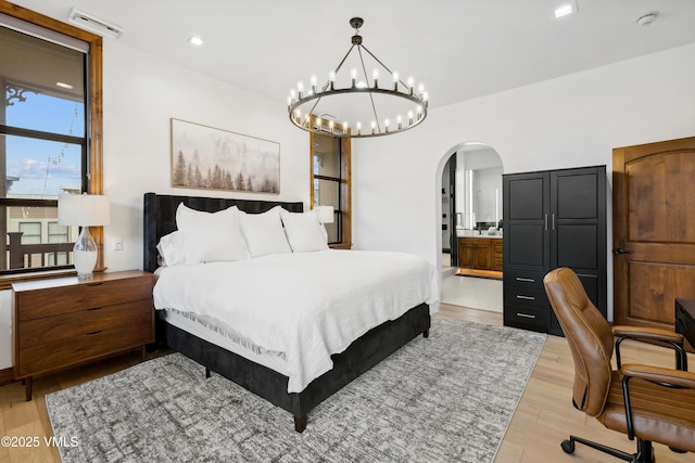 295 Main St Unit R305, Edwards, CO 81632 - bedroom featuring arched walkways, a chandelier, light wood-type flooring, and recessed lighting