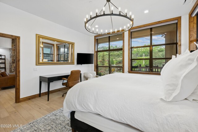 295 Main St Unit R305, Edwards, CO 81632 - bedroom with a chandelier, light wood-type flooring, and baseboards