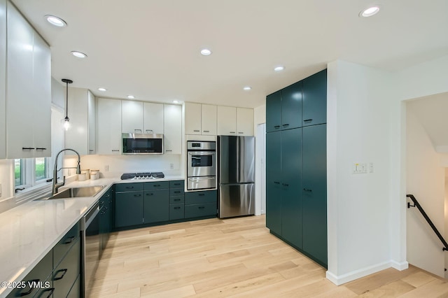 1359 Greenhill Ct Unit E, Vail, CO 81657 - kitchen with appliances with stainless steel finishes, a warming drawer, light wood finished floors, light countertops, and recessed lighting