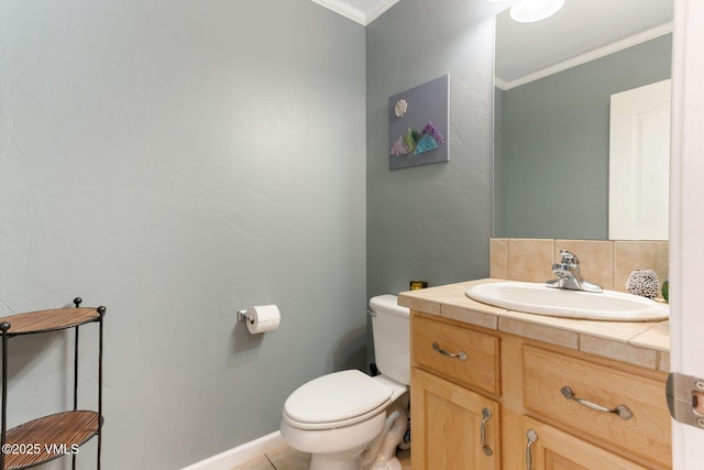 half bath with vanity, baseboards, crown molding, toilet, and tile patterned floors