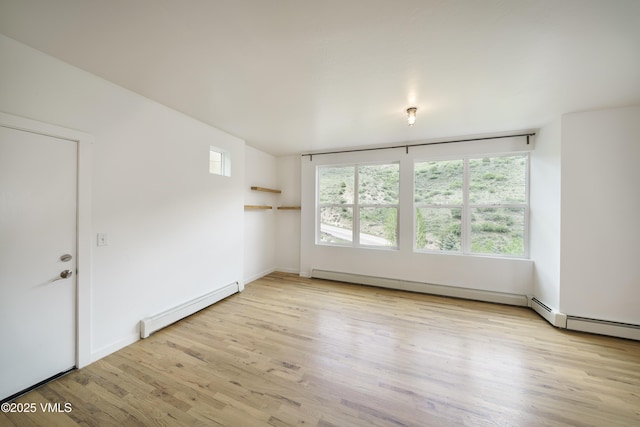511 Metcalf Unit J30, Avon, CO 81620 - empty room featuring a baseboard heating unit, light wood finished floors, and baseboards