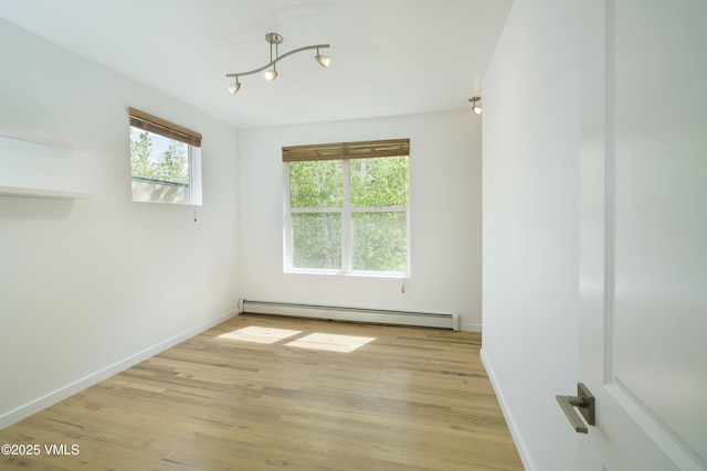 511 Metcalf Unit J30, Avon, CO 81620 - spare room with a baseboard heating unit, baseboards, and light wood-style flooring