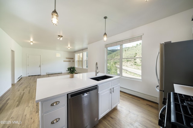 511 Metcalf Unit J30, Avon, CO 81620 - kitchen featuring stainless steel appliances, a sink, baseboard heating, and a baseboard heating unit