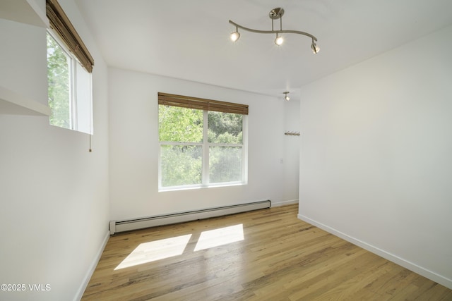 511 Metcalf Unit J30, Avon, CO 81620 - spare room with a baseboard heating unit, baseboards, and wood finished floors