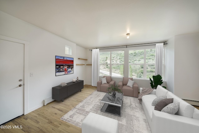 511 Metcalf Unit J30, Avon, CO 81620 - living room with wood finished floors, baseboard heating, a baseboard radiator, and baseboards