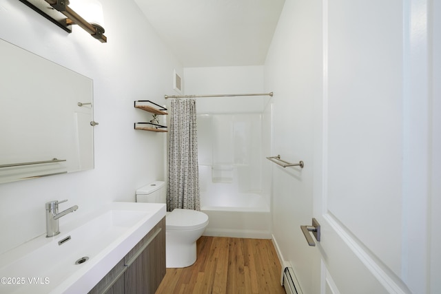511 Metcalf Unit J30, Avon, CO 81620 - bathroom featuring vanity, toilet, wood finished floors, shower / bath combo, and a baseboard radiator