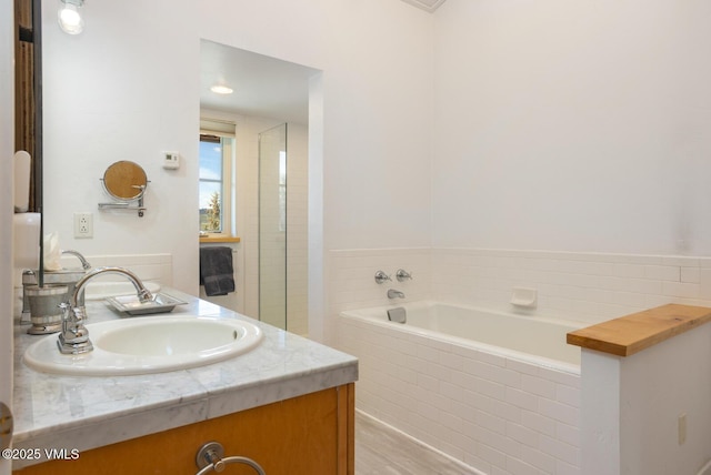 12 June Creek Rd, Edwards, CO 81632 - bathroom with a bath, wood finished floors, and vanity