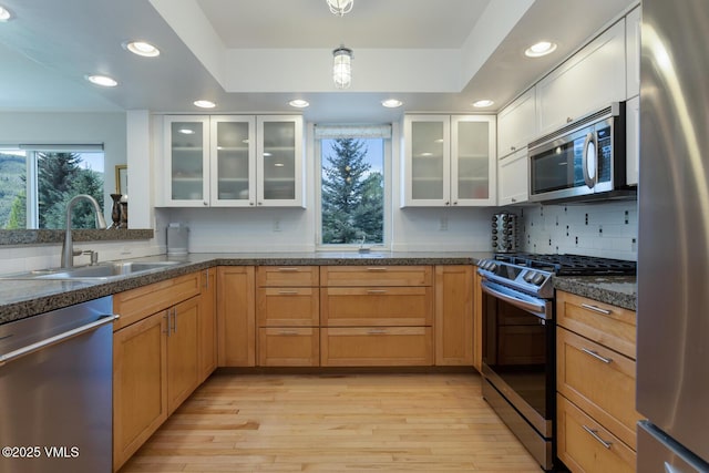 12 June Creek Rd, Edwards, CO 81632 - kitchen with appliances with stainless steel finishes, a sink, light wood-type flooring, backsplash, and recessed lighting
